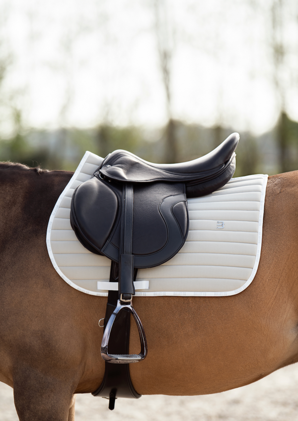 beige saddle pad jumping