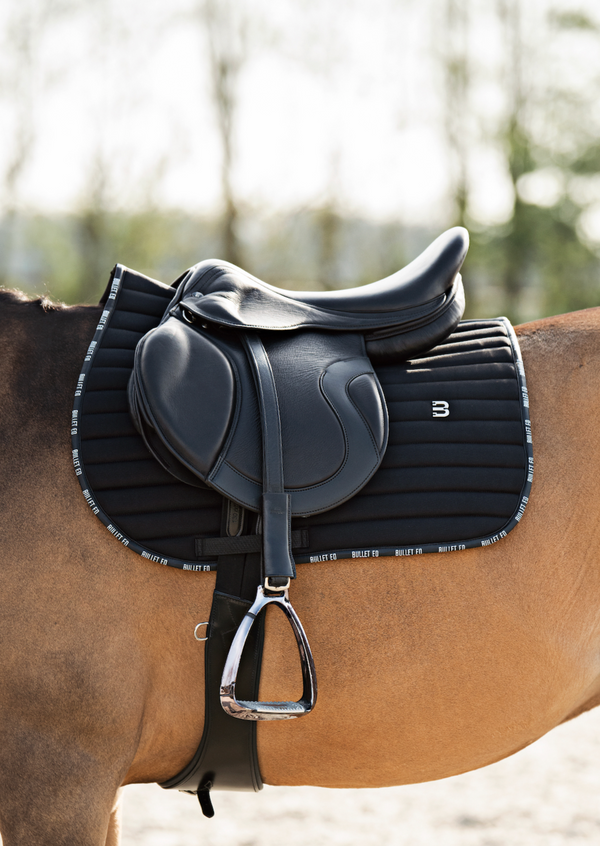 black saddle pad jumping