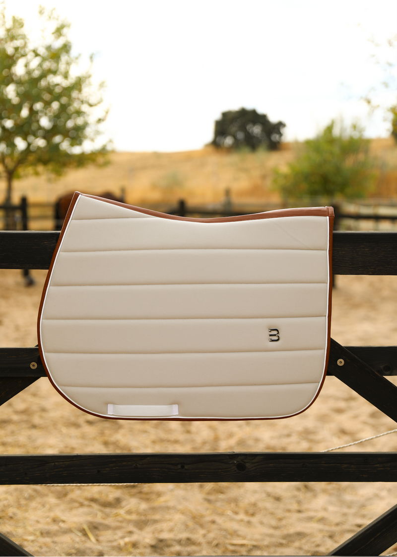 Beige leather saddlepad jumping