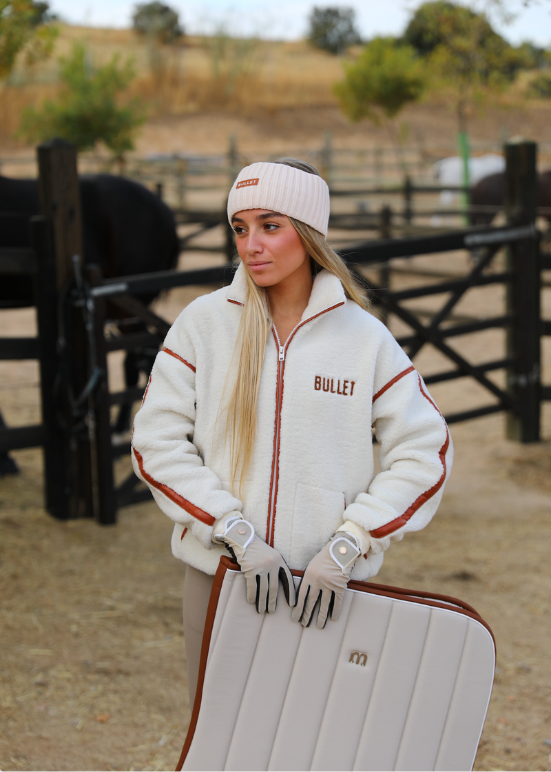 Beige leather saddlepad jumping