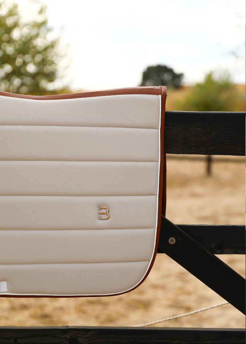 Beige leather saddlepad jumping